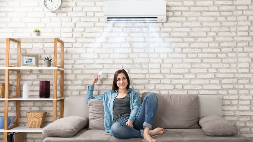 Delco Air HVAC technician servicing a residential heating and cooling system for optimal climate control.